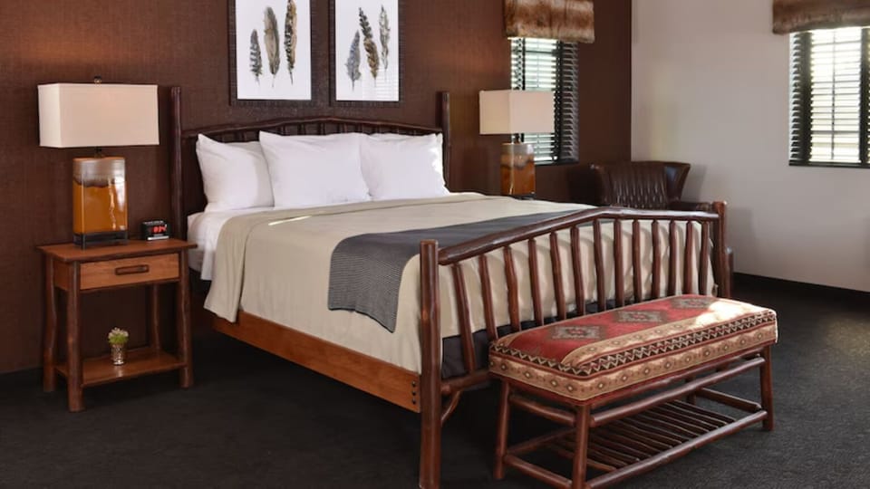 Unwind into crisp linens on a warm, rustic king bed.