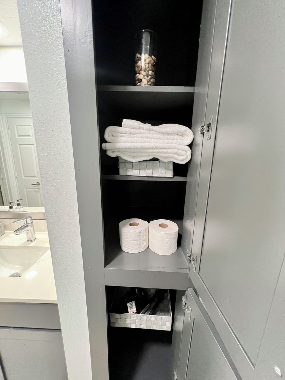 Towels, toilet paper, flat iron and hair dryer.