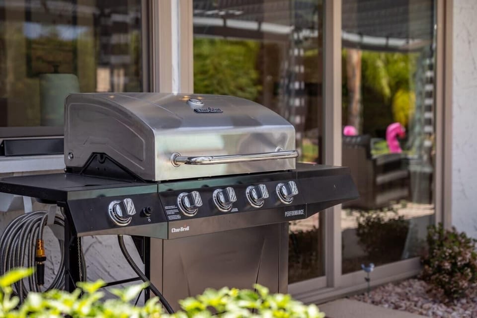 Outdoor Char-Broil five-burner gas grill on the patio — fire it up and keep the whole group fed without leaving the house