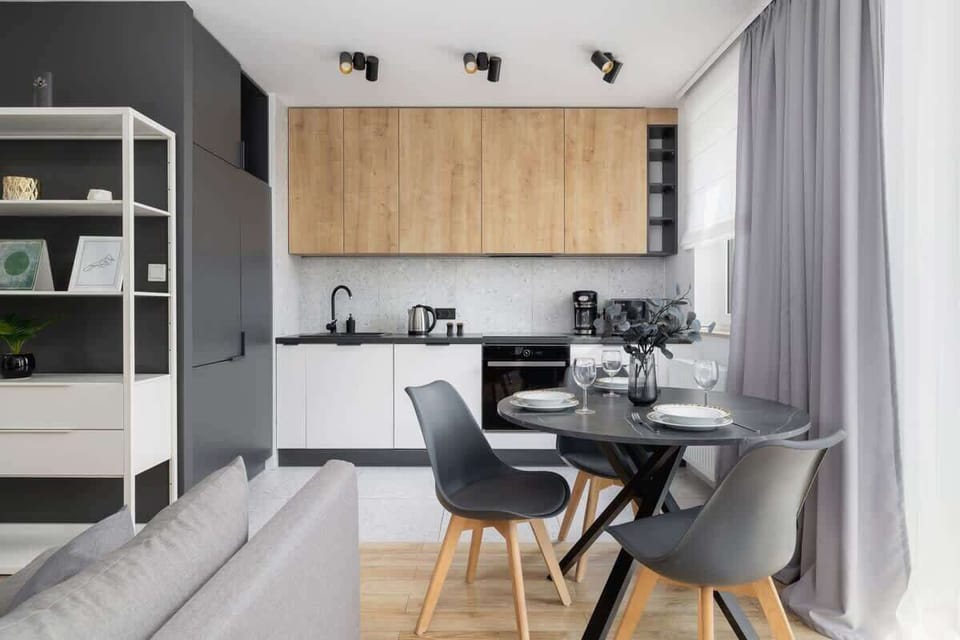 A unique living room with a practical kitchenette.
