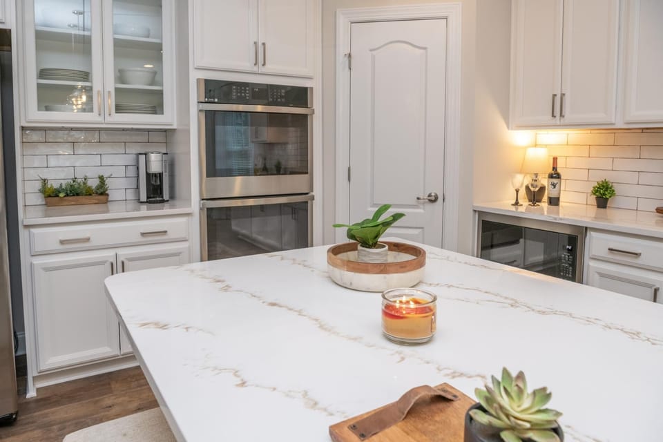 The gourmet kitchen features double ovens and a microwave.