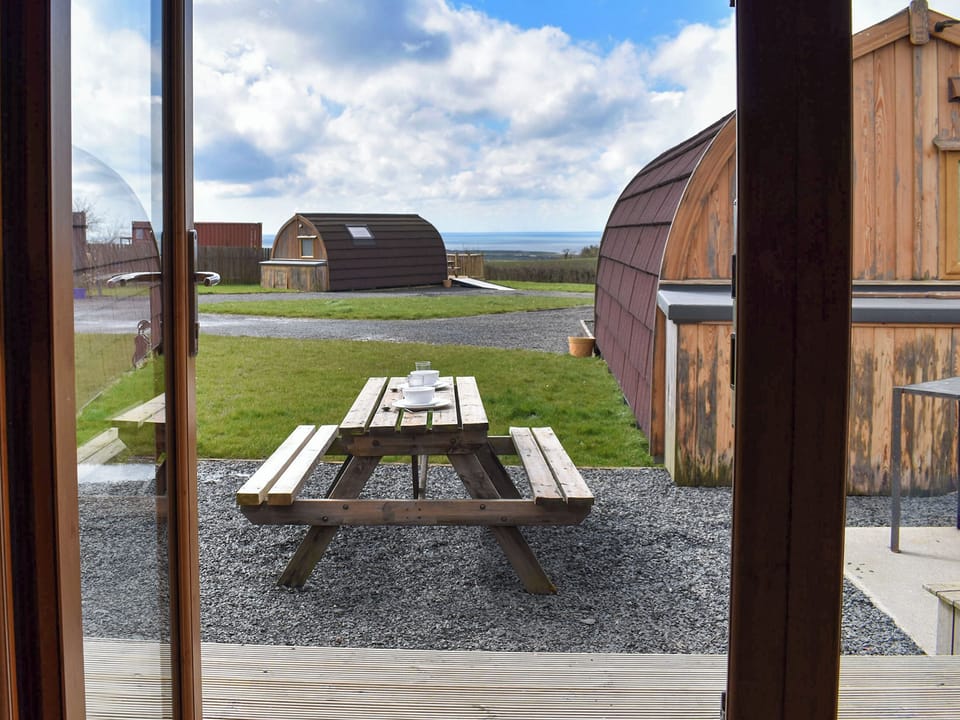 Decked terrace with outdoor furniture | Withy Bottom - Moorside Glamping Pods, Corney, near Millom