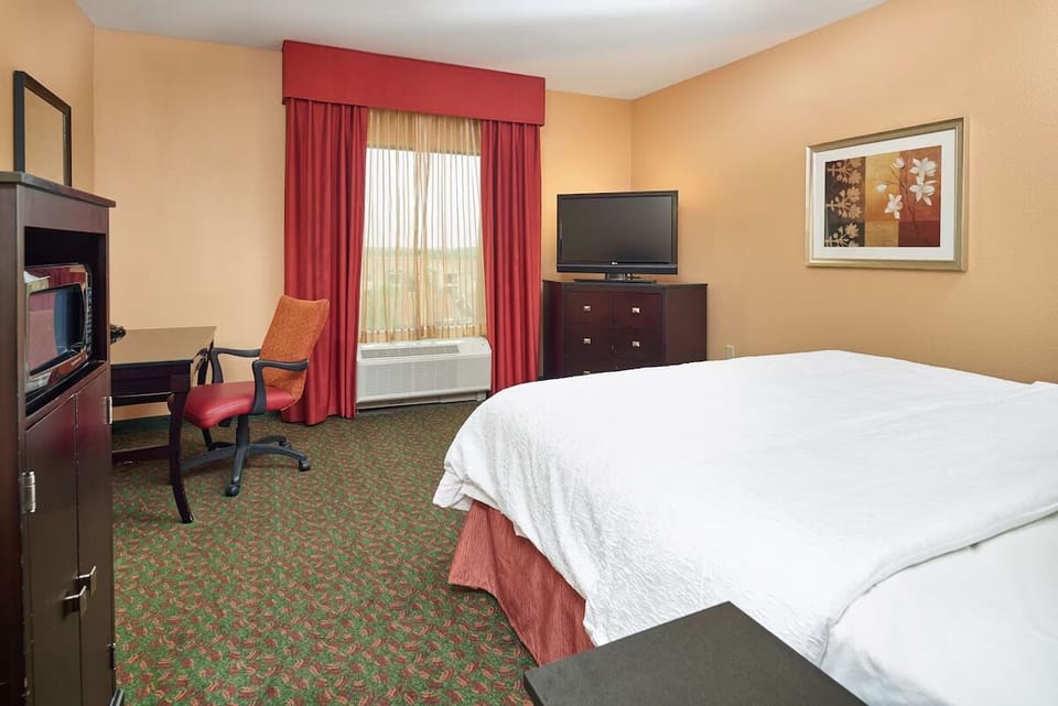 Recharge in a warm, quiet room with bedside lighting.
