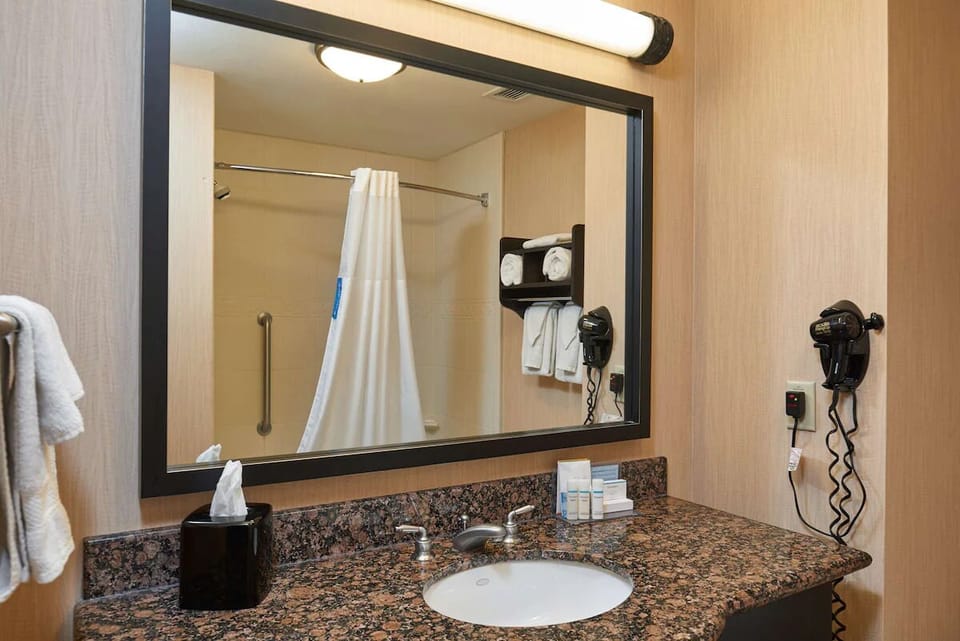 Refresh effortlessly with a bright vanity and accessible shower.
