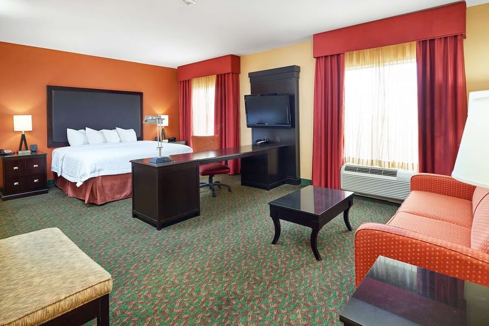 Spread out in a roomy suite with bed and lounge seating.