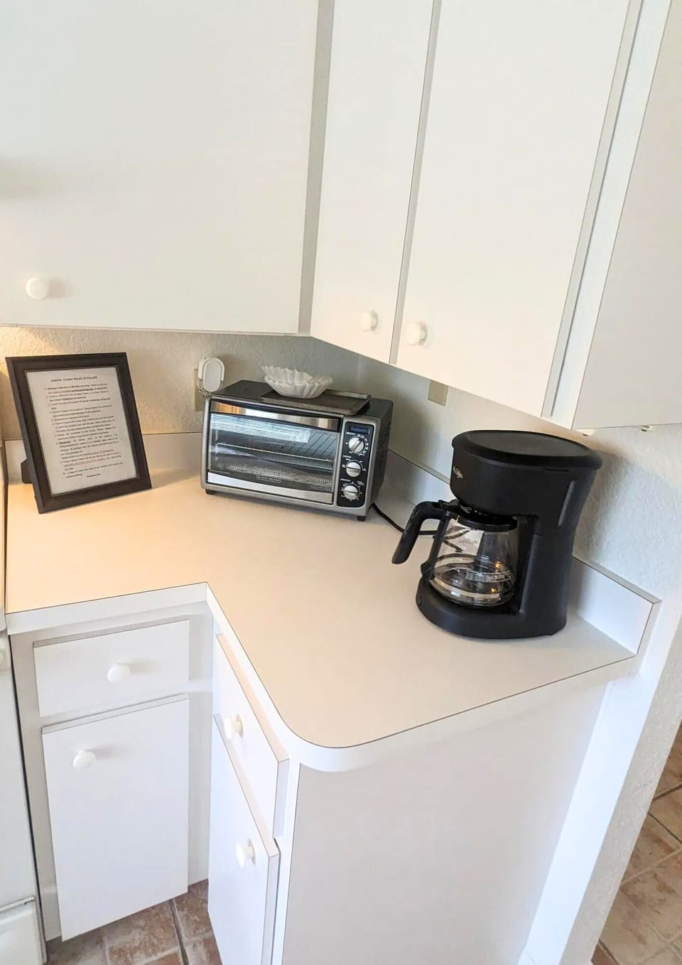 Kitchen features essential appliances such as an oven and water heater.
