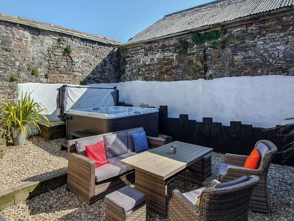 Private courtyard with hot tub, seating for 6 | Puffin House - Blegberry Farm, Hartland