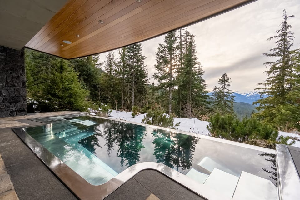 Main level patio with a very large hot tub and outdoor lounge seating.