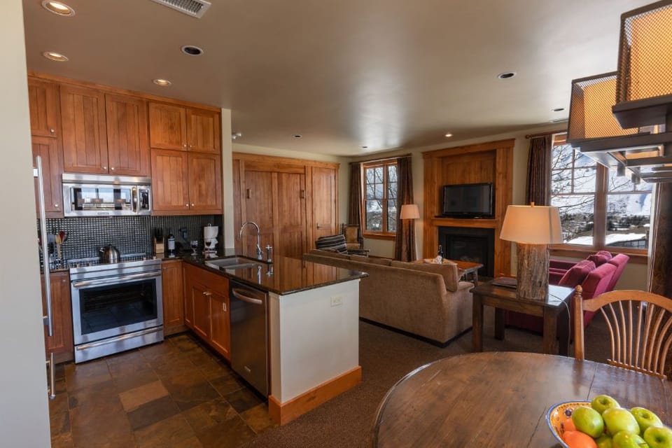 Open-concept kitchen with bar seating and stainless steel appliances.