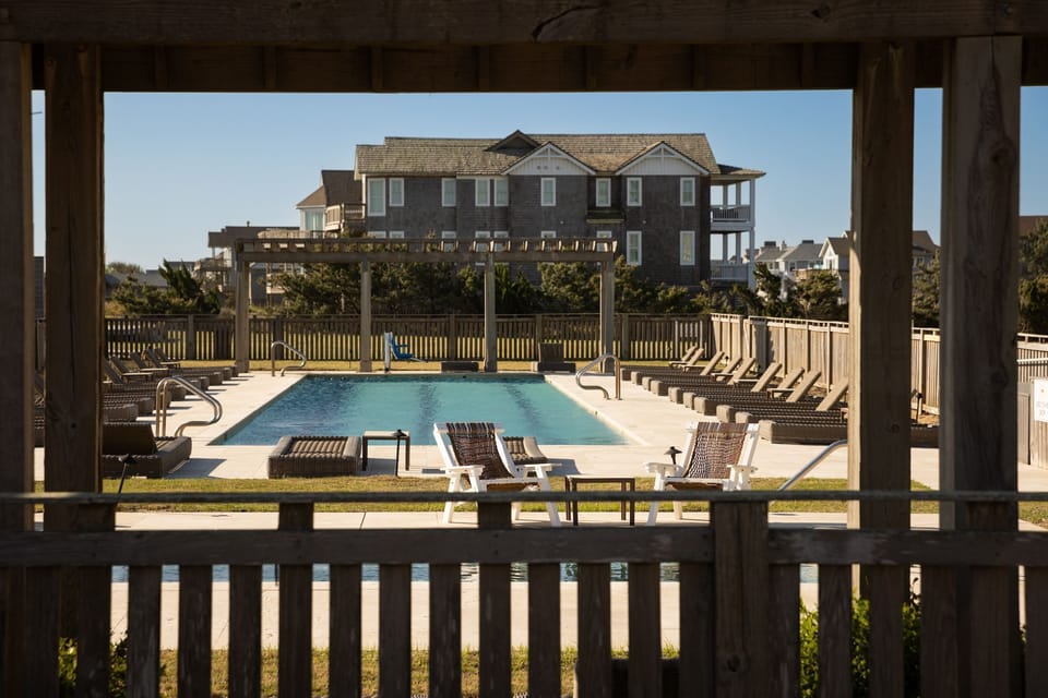 Unwind by the outdoor pool, surrounded by sun loungers and the open skies of Duck, NC