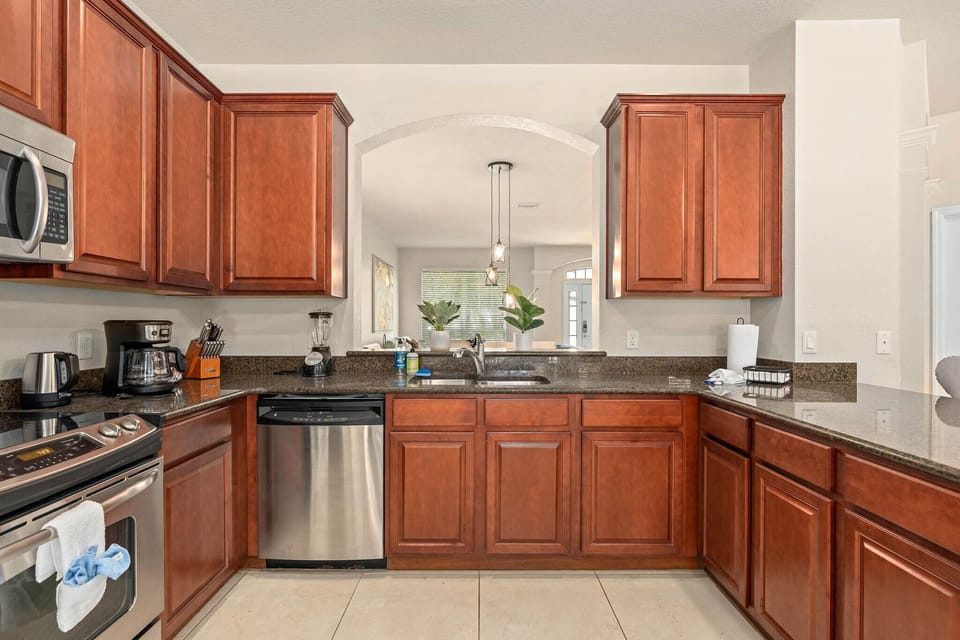 Enjoy culinary delights in a style with sleek appliances & natural light!