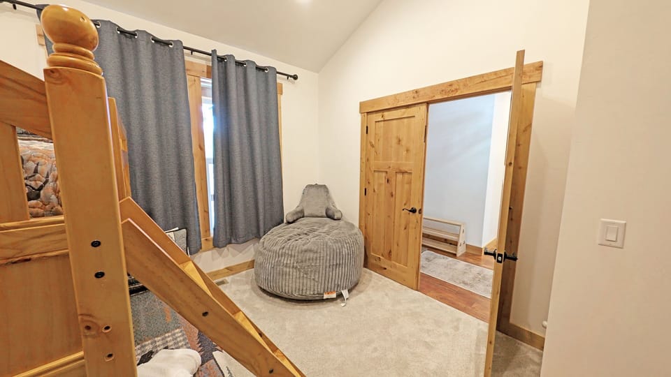 Bunk Room with Pyramid Bunk and Oversized Stuffed Chair