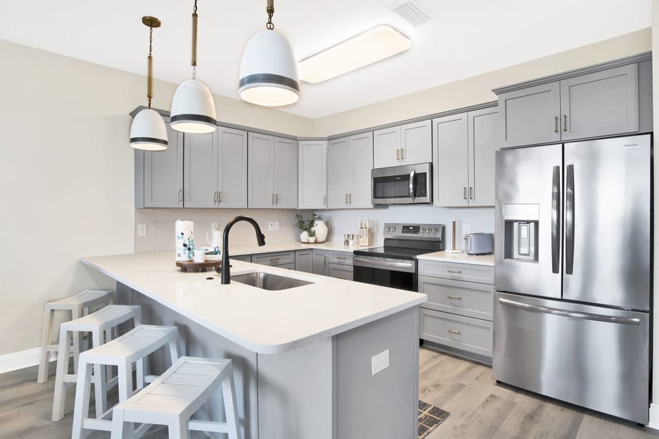 A seamless blend of sleek appliances and cozy accents in a kitchen that's the heart of the home