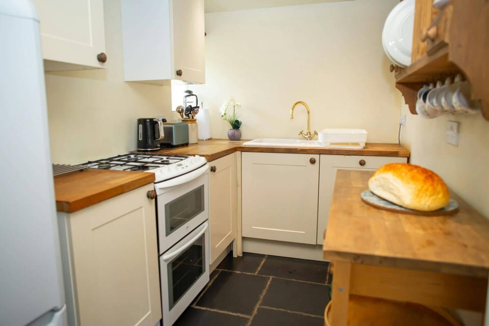 Kitchen with fridge/freezer and gas cooker, kettle and toaster