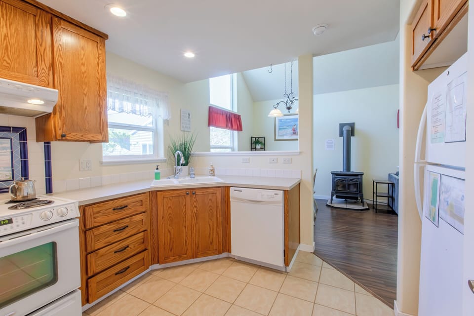 Kitchen area looks into dining room and living room