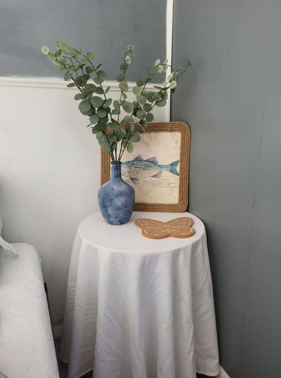 Simple details, like a fresh vase of greenery, make the space feel alive.