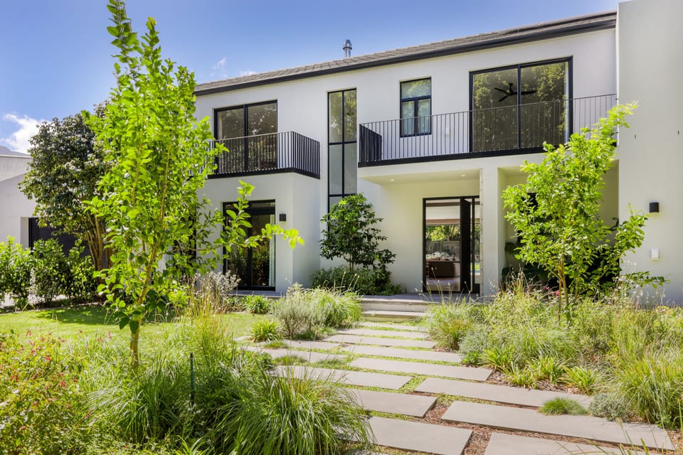 Modern double storey home with 4 bedrooms upstairs and a guest suite downstairs.