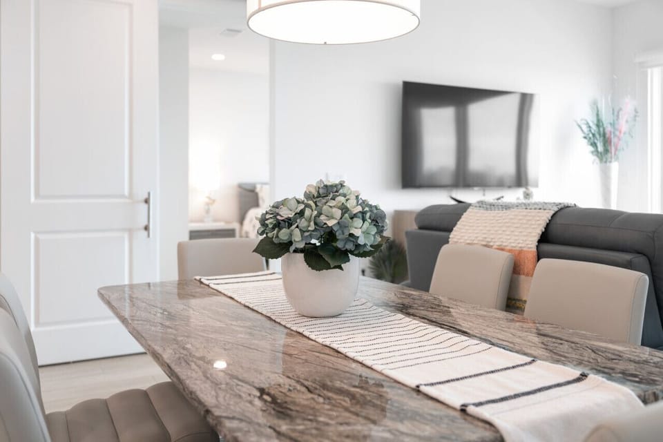 Bright dining nook w/ a welcoming table, perfect for easy meals & morning coffee.