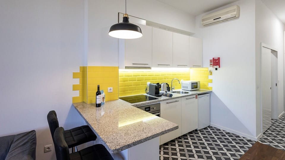 Explore your culinary skills in our compact yet well-equipped kitchenette, ideal for whipping up quick meals #practical #contemporary
