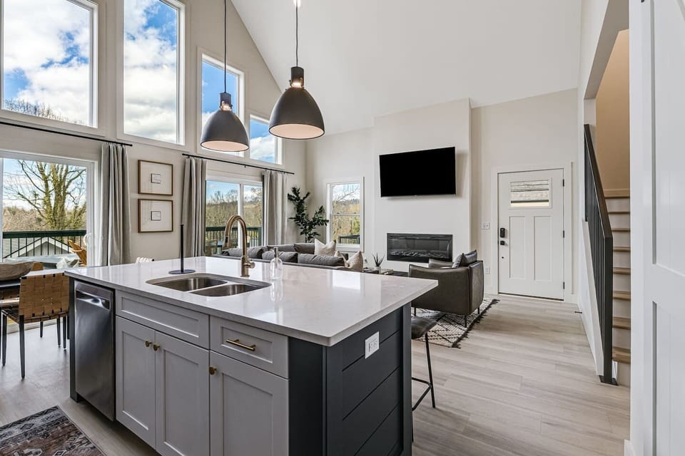 View from the kitchen looking at the front door; stairs leading to 2 upstairs bedrooms and upstairs full bathroom