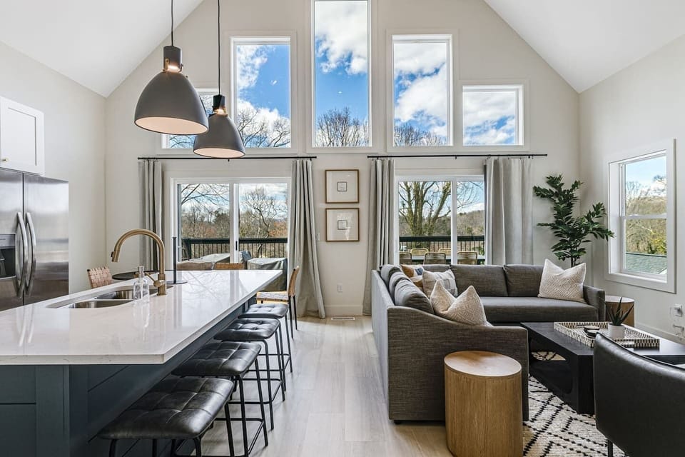 Professionally designed, open-space living room, kitchen, and dining area with a large, walk-out upper deck