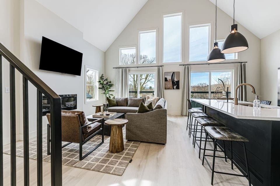 Professionally designed, open-space living room, kitchen, and dining area with a large, walk-out upper deck