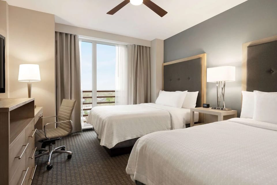Settle into two cozy beds beside bright balcony doors.
