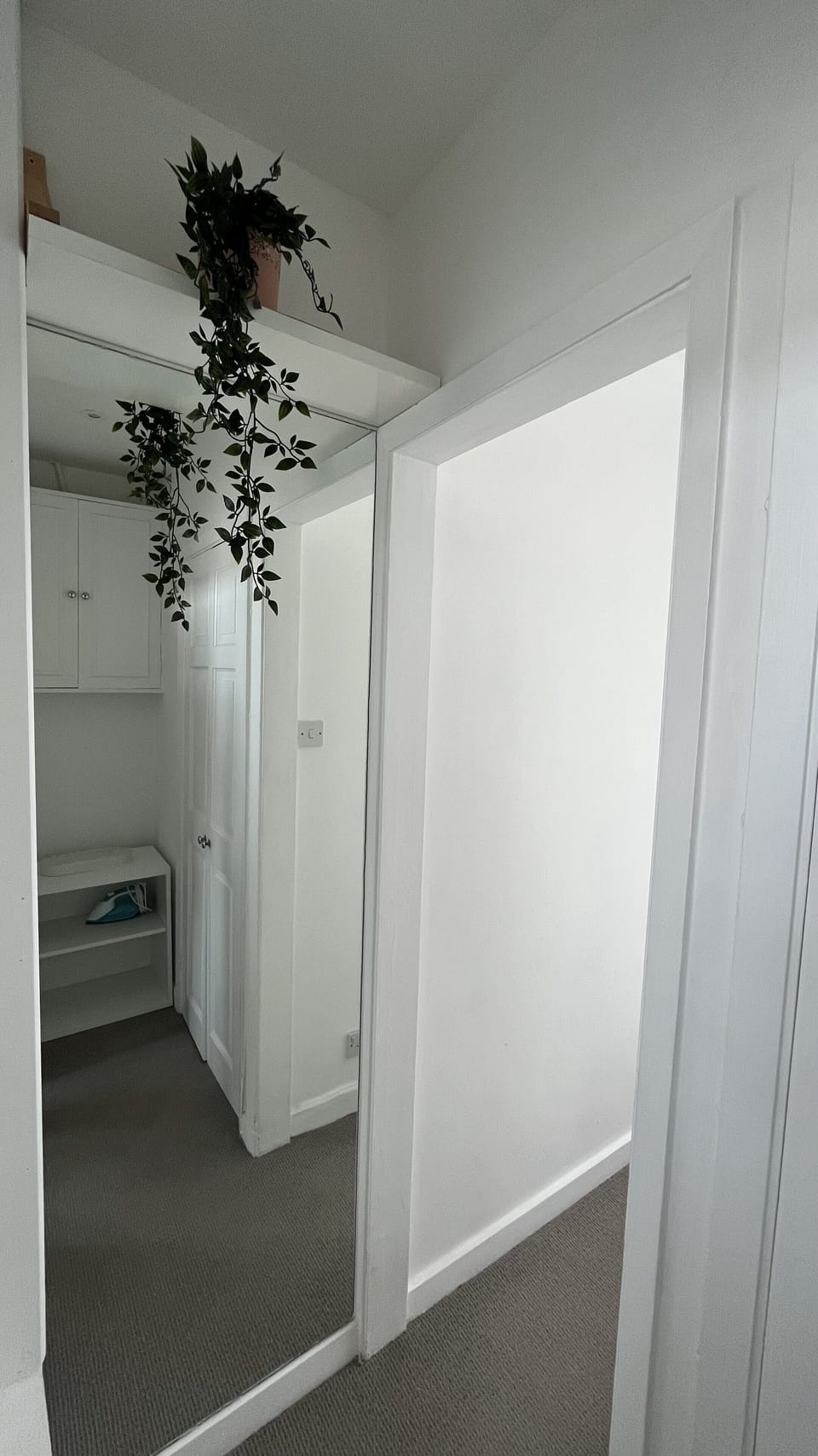 Closet and dressing area with a full-height mirror.