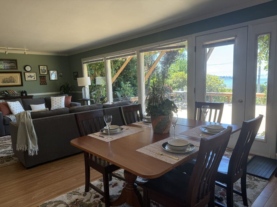 The dining area flows into the living area and outside to the expansive deck