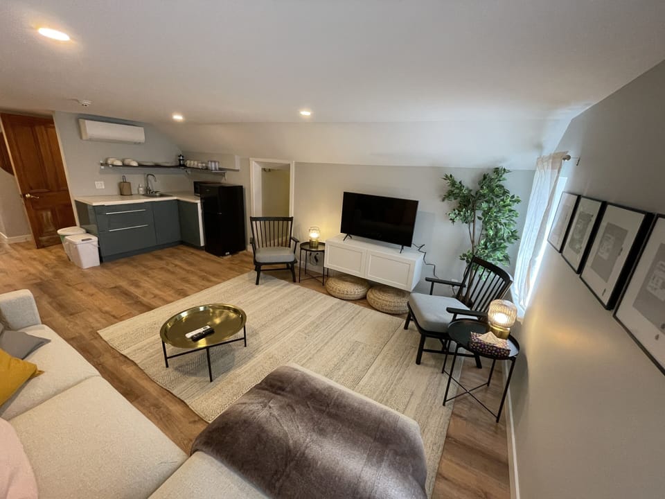 living room, kitchenette, and emergency exit hallway