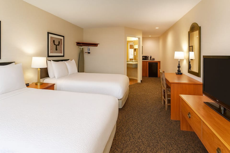 Spread out comfortably with two queen beds and warm lighting.