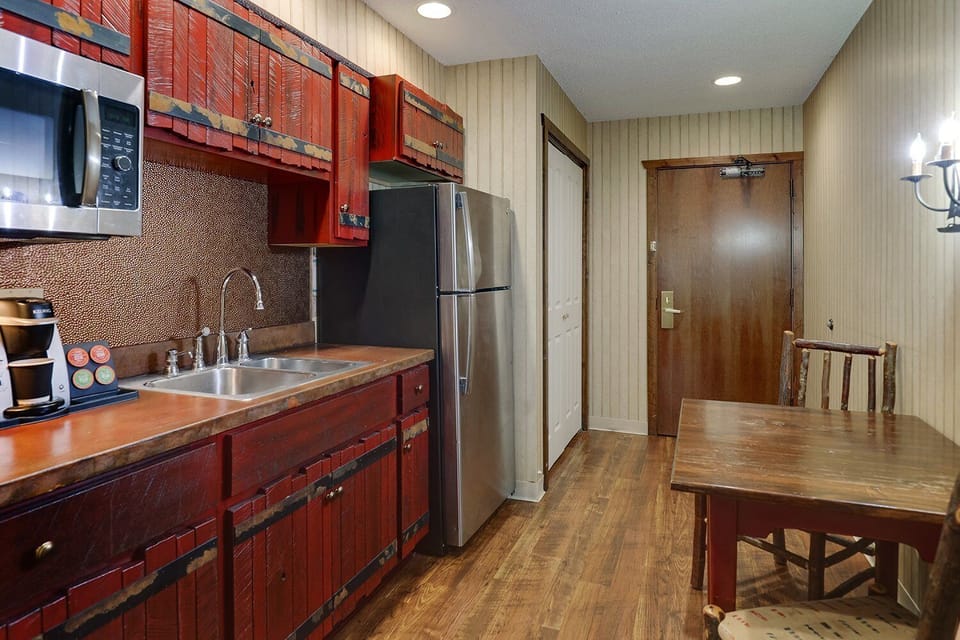 Prepare snacks anytime with microwave, sink, and full fridge.