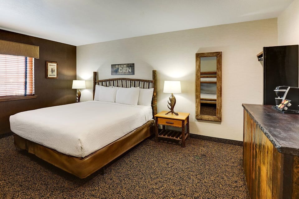 Drift off in a serene room with warm lodge accents.