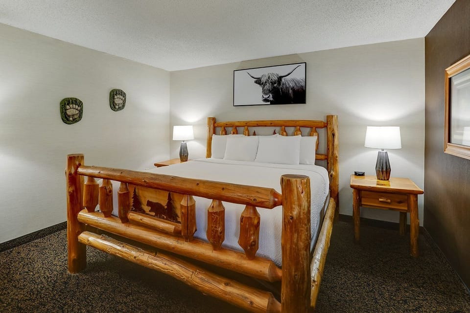 Drift off in a rustic log bed with plush linens.