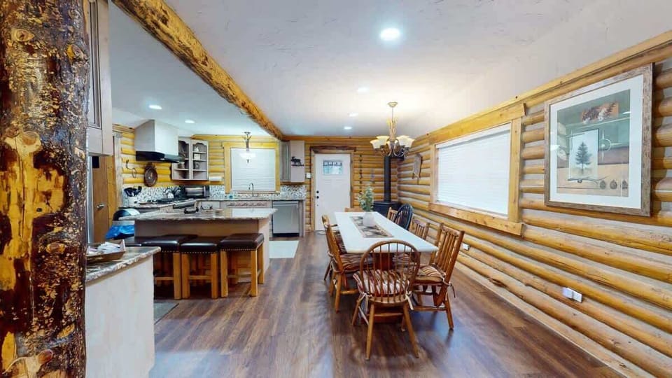 Large open kitchen and dining area equipped to host a home cooked meal.
