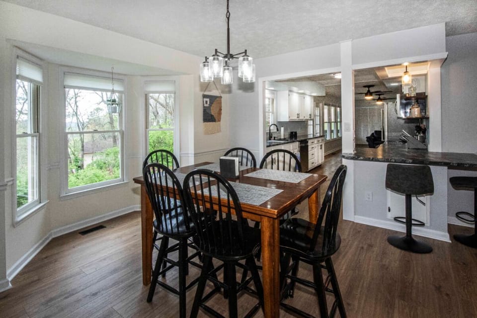 Bar height dining table with 6 chairs, two bar stools at counter
