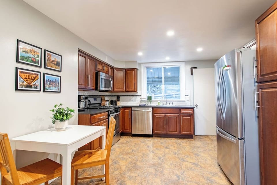 Fully equipped kitchen with modern appliances, plus an additional dining table for two, offering a cozy space for meals or casual dining.