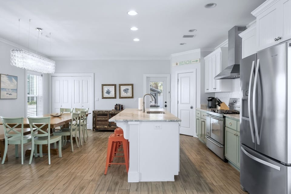 Full kitchen with door leading to the backyard and pool area 