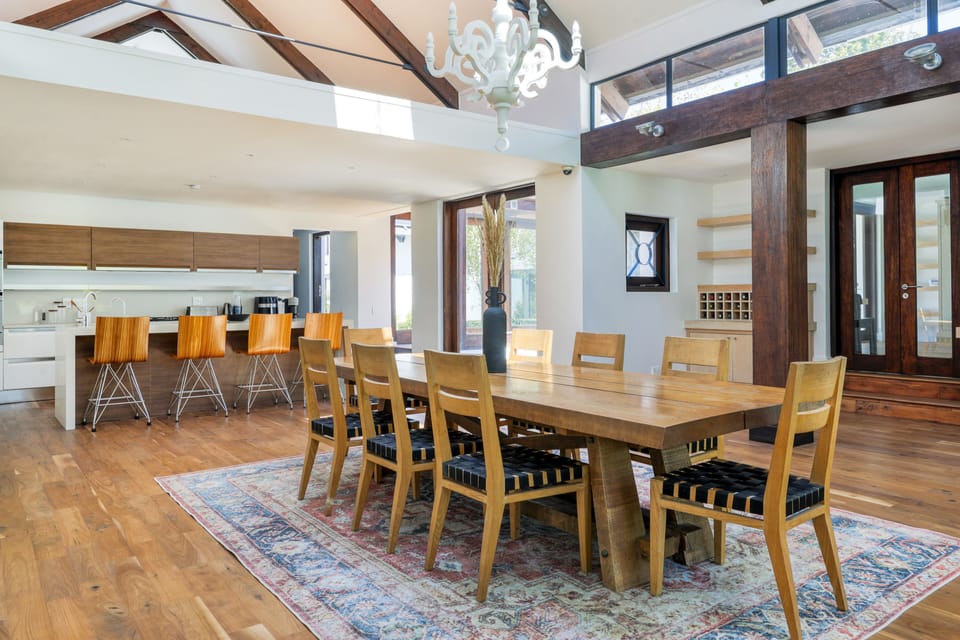 8 seater dining table with open plan kitchen in the back with separate scullery.