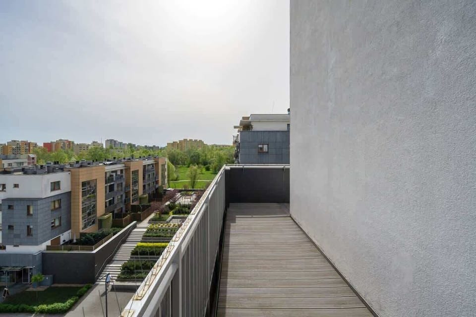 Balcony with a table, two glasses, and a plant