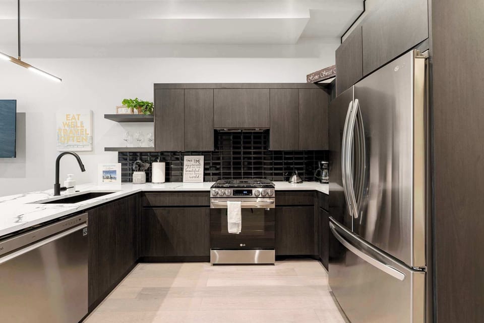 Modern kitchen wrapped in rich cabinetry for simple meal prep.