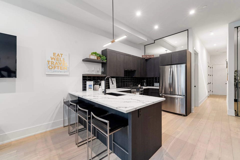 Sleek kitchen w/ roomy island for cooking & gathering.