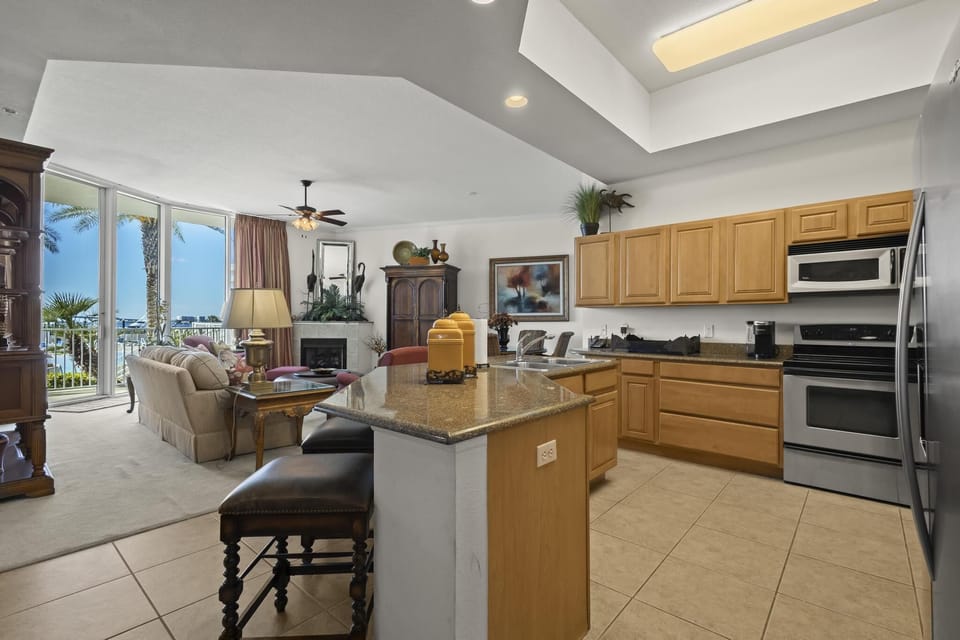 Kitchen - The kitchen is fully stocked with all items needed for preparing your meals during your stay. Enjoy the awesome views this great unit offers even while cooking!