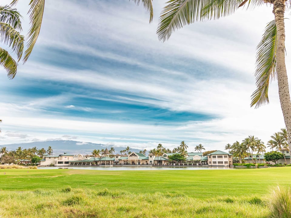 The large lanai provides a beautiful extension of your living space, offering direct views of the green grass and the expansive golf course beyond.
