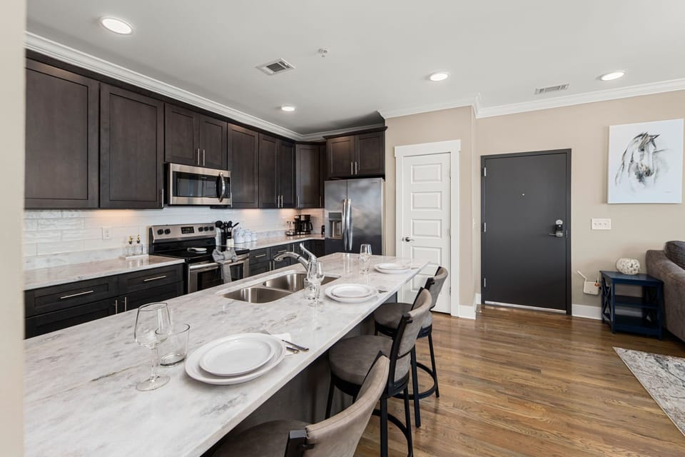 Kitchen features stainless steel appliances and cooking basics.