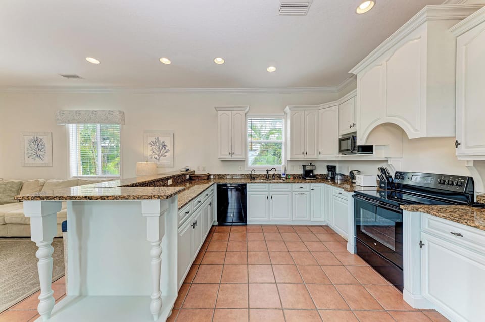 Gather in this spacious kitchen, where granite countertops and stainless appliances set the stage for your culinary adventures. Plenty of cabinet space and a large island make meal prep feel effortless.