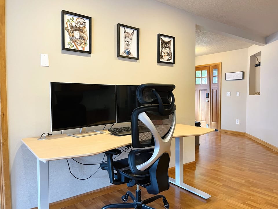 Full workspace desk with two 32" monitors and chair