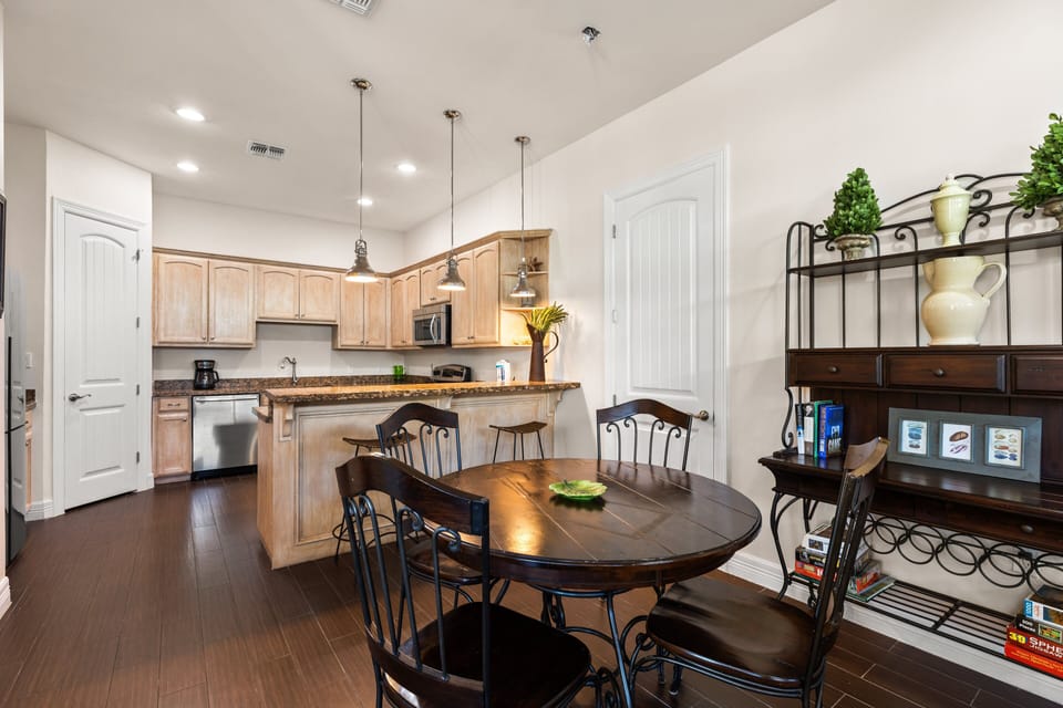 Open concept layout featuring dining table for 4 and extra seating on the kitchen bar