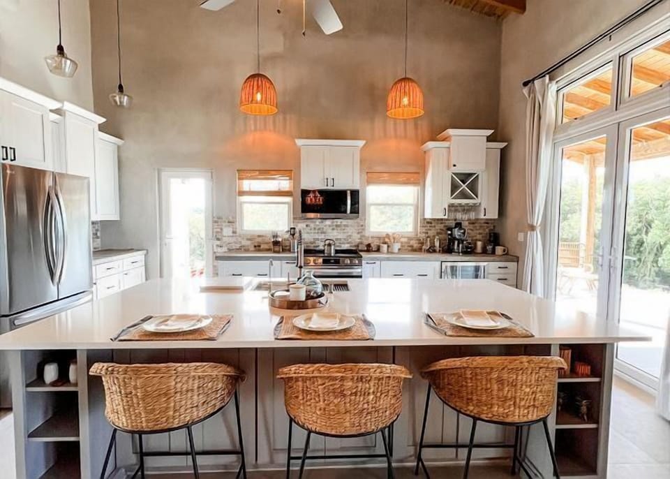 Large quartz countertop island with barstool seating.