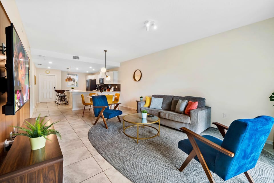 - Alluring Living Area of the Condo in Kissimmee Florida - Harmonious color scheme with pops of accent colors for visual interest - Cozy seating area conducive to relaxation and socializing - Smart TV and Netflix